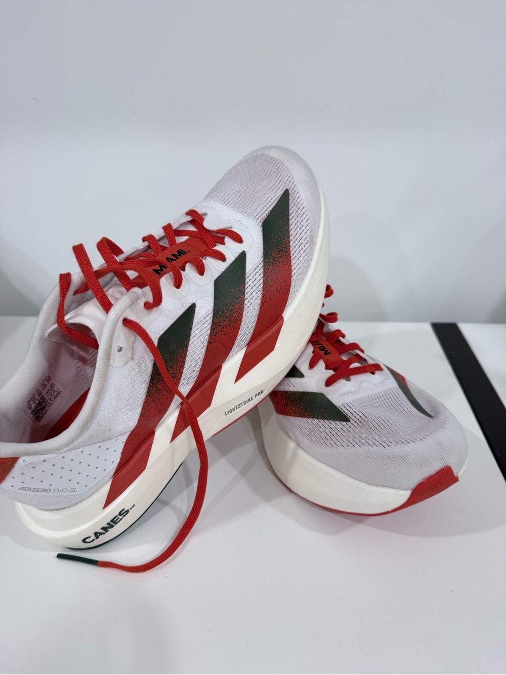 adidas Men’s White Running Shoes with Red and Dark Green Accents